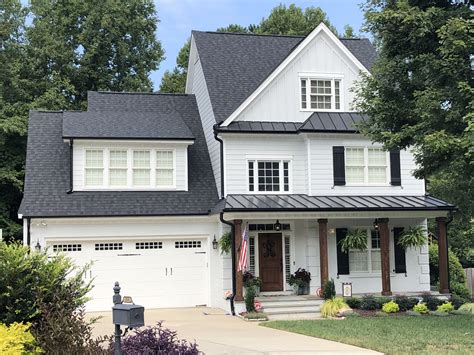 6 black gutters on white house with black metal roof|white farmhouse with black gutters.